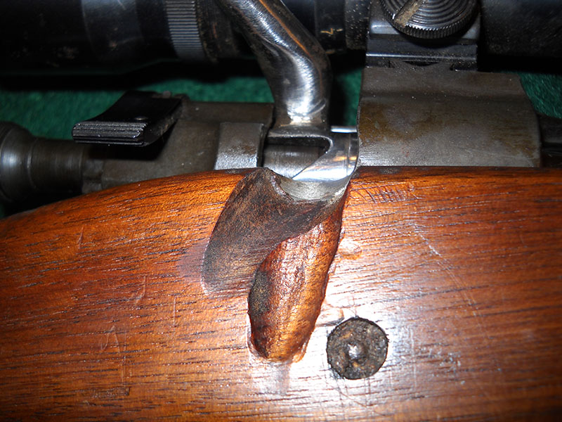 closeup of bolt handle, open, with stock cutaway